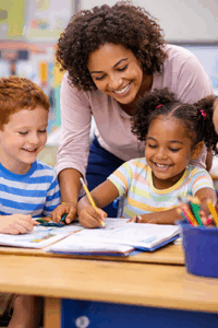 A teacher and two children, smiling, doing school related activities